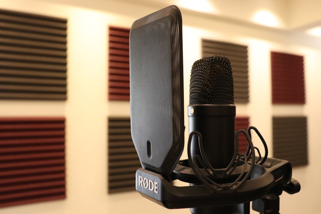Artist recording into a microphone in a studio