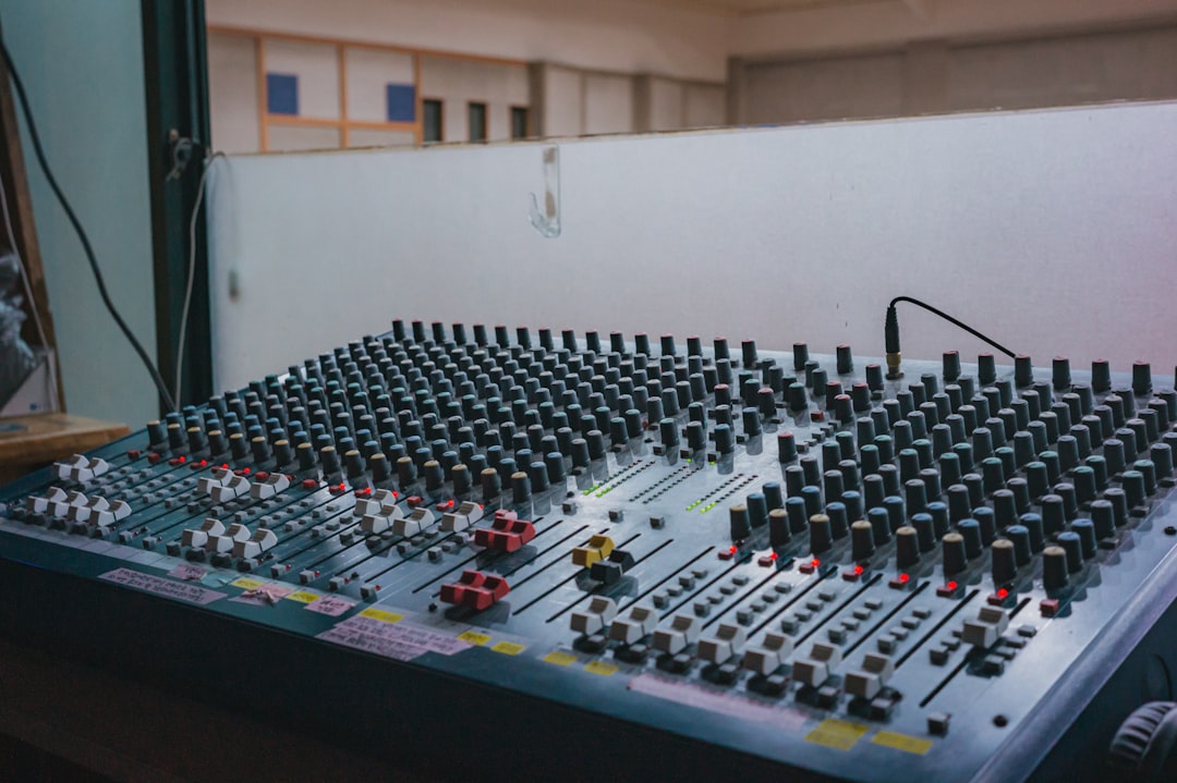 Close-up of an audio mixing console faders in a studio