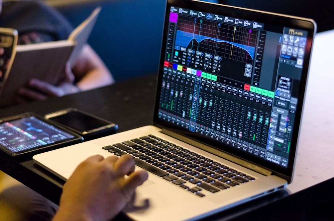 Music production workstation with DAW software in a dark studio